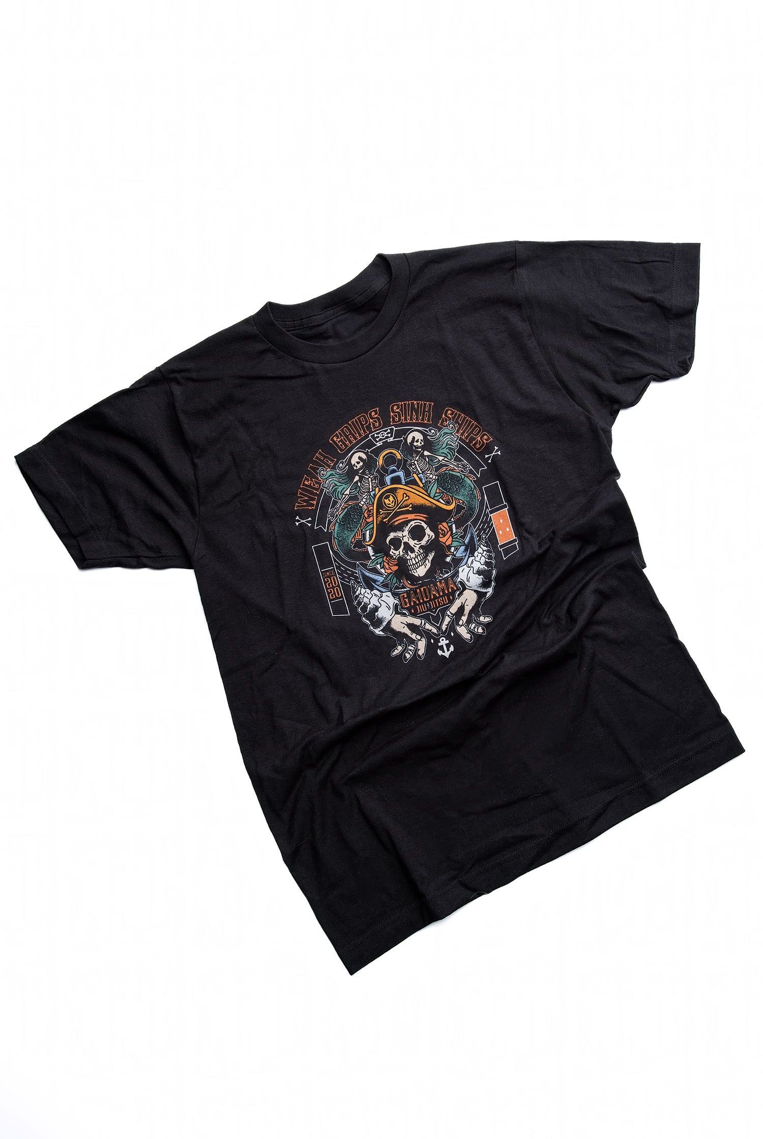 A BJJ t-shirt featuring pirate themed elements including skulls, shells, and mermaids, with lettering that says Weak Grips Sink Ships, as opposed to the old wartime saying Loose Lips Sink Ships.