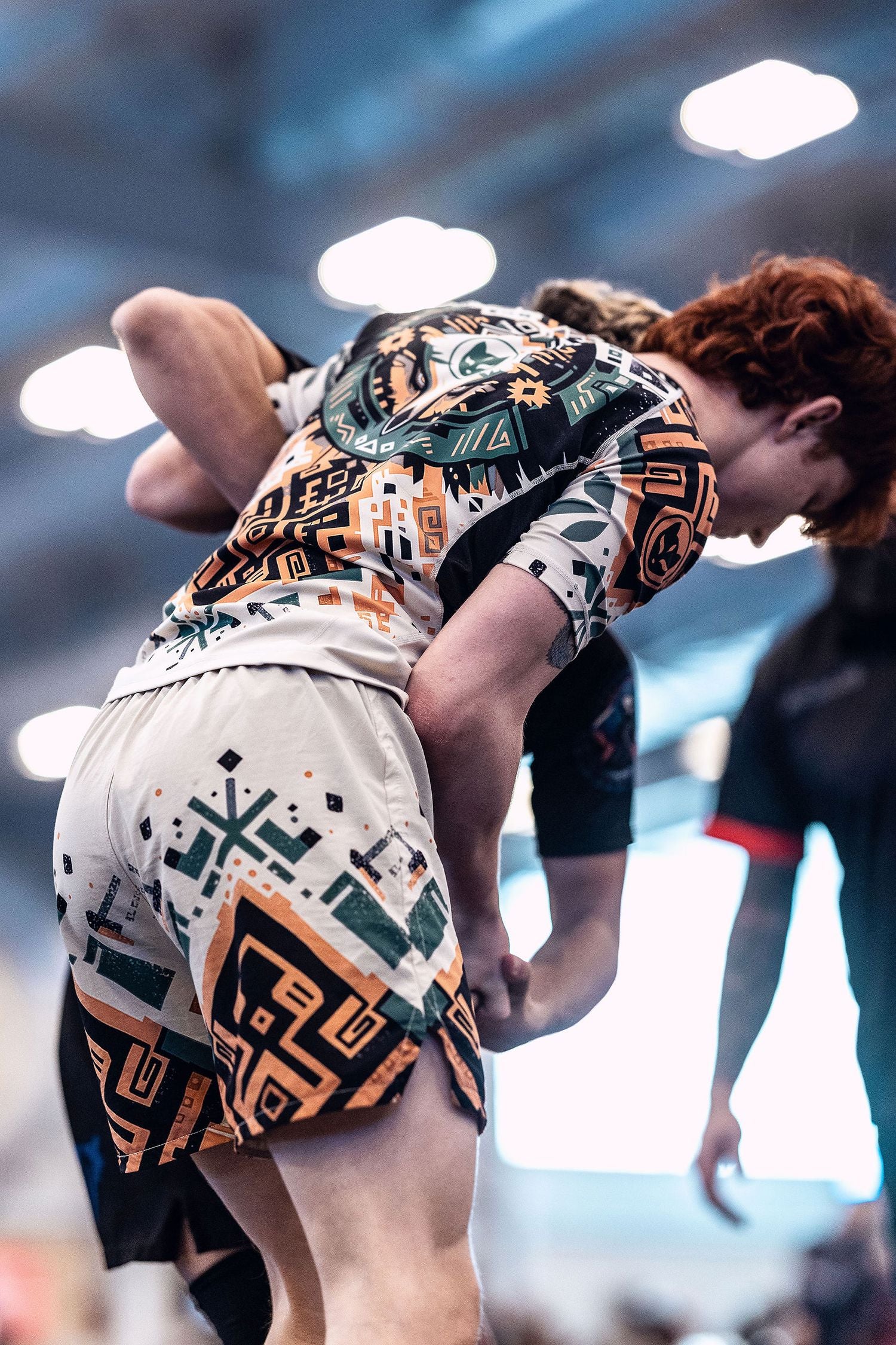 Young man wearing the men's Desert Relic Jiu Jitsu rashguard and nogi BJJ shorts winning the underhook wrestling at an ADCC Open Jiu Jitsu tournament.